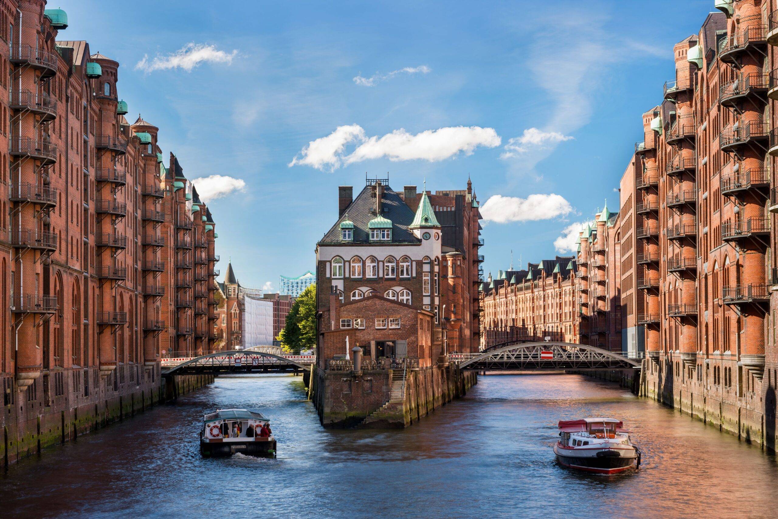 Klassenfahrt Hamburg: Speicherstadt Hamburg mit Blick auf das Wasserschloss und zwei Boote auf dem Kanal
